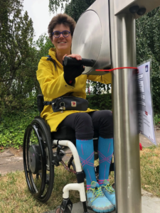 exercises on the playfit Arm Cycle K05035 in a park with safety surfacing